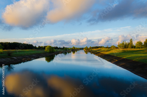 Blue river. Reflection of clouds in the water