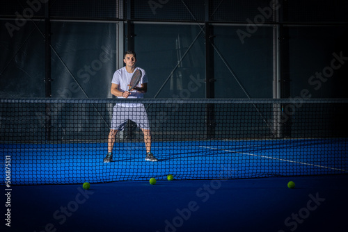 Man playing padel tennis indoor