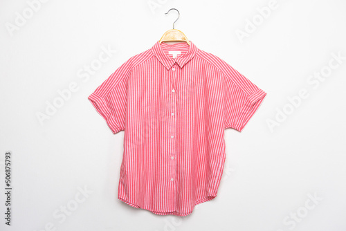 pink shirt on hangers.