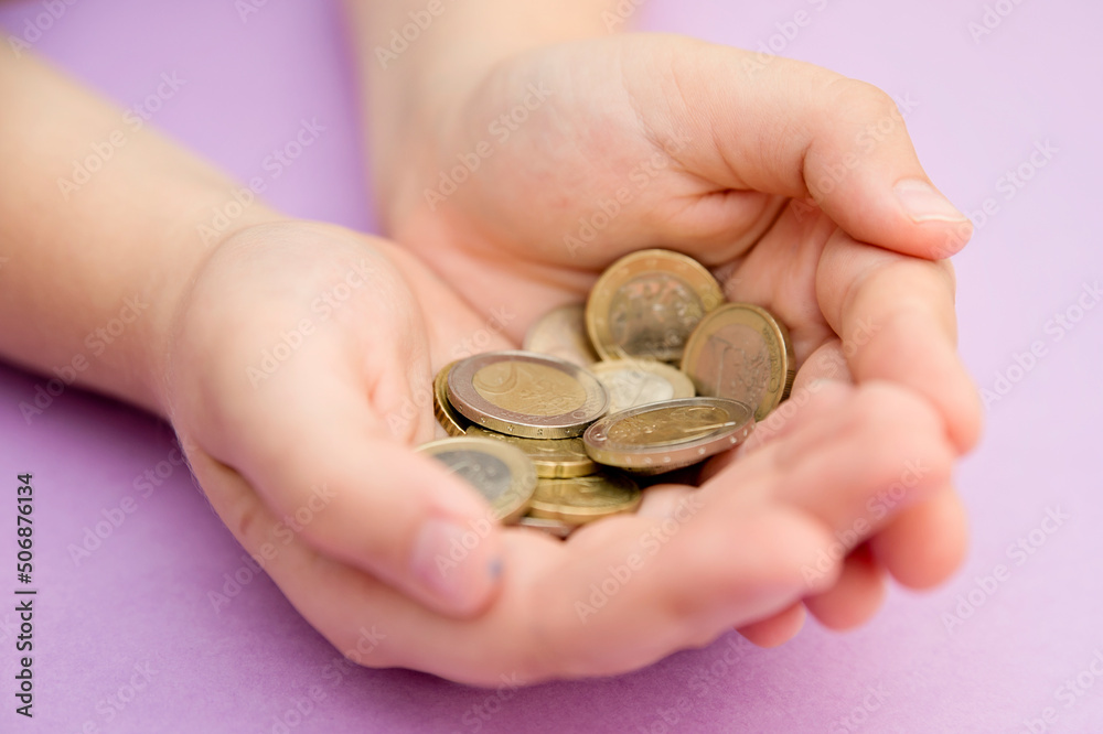 Euro coins in kids hands. Currency transfer, investment, payment, donation, gift concept. Saving money for the future, education, car, weddings. Euro coins in kids hands. Currency transfer, investment, payment, donation, gift concept. Saving money for the future, education, car, weddings.