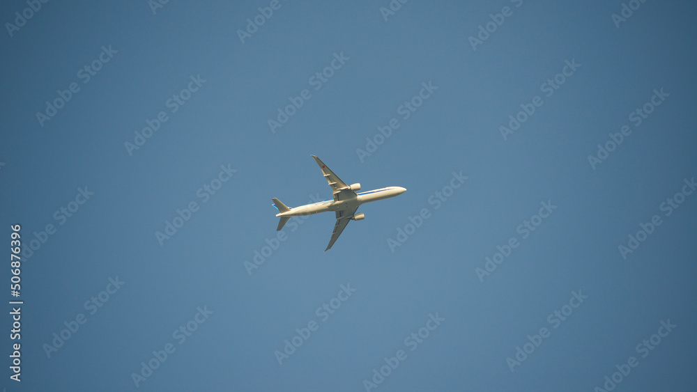 Airplane shortly after takeoff against a clear blue sky Airplane shortly after takeoff against a clear blue sky