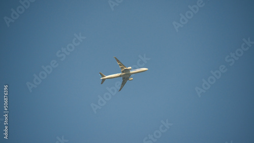 Airplane shortly after takeoff against a clear blue sky