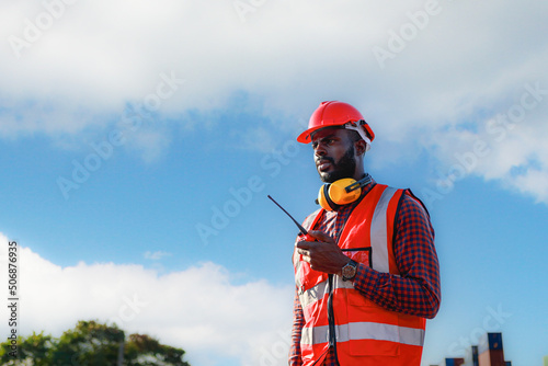 Engineer foreman, male African American, controls the inspection. Warehouse at container