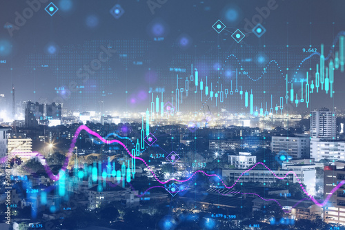 Forex market exchange concept with double exposure of night megapolis city and abstract technology background with digital financial graphs and growing candlestick © Who is Danny