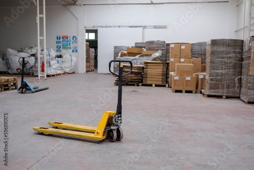 hand pallet truck, in the warehouse part of the factory. Selective Focus pallet truck