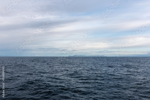 Seascape from Norwegian Sea in Atlantic Ocean with distant mountains, cloudy day in summer © OKemppainen