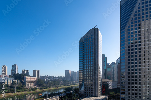 Aerial view of the Marginal Pinheiros Avenue, Pinheiros River, corporate buildings and skyline of Sao Paulo city in sunny summer day. Brazil. #506884700
