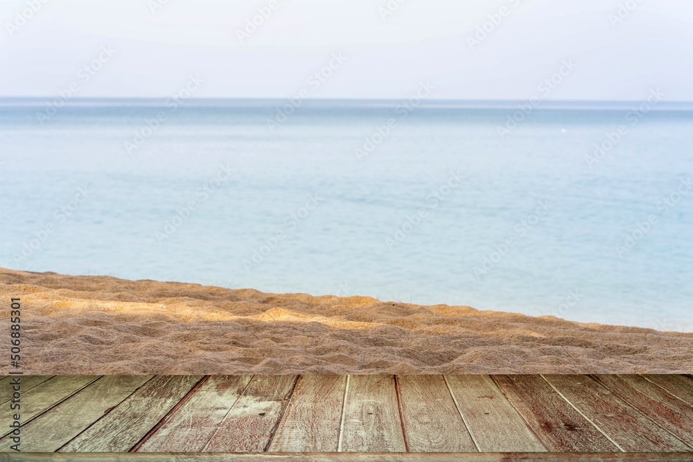 Fototapeta premium Old wood texture Table Against Sand Beach Background.