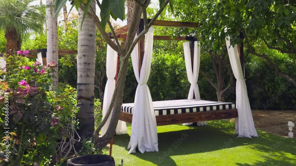Beautiful and luxurious outdoor white four poster bed with white