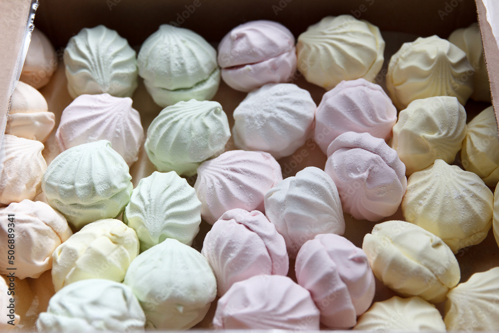 Fresh sweet air marshmallow lies in cardboard packaging prepared for sale in stores