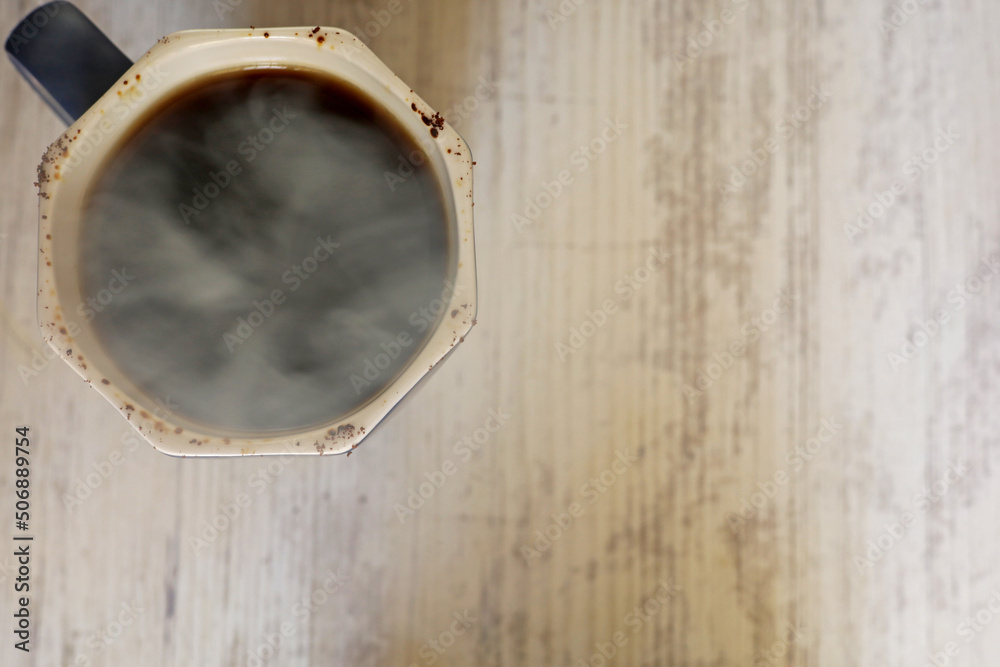 a cup of coffee on the wooden table
