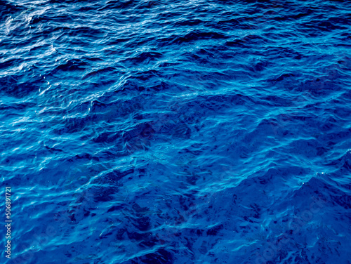 Close up of a calm water surface. Abstract nature background. Various shades of gray and blue.