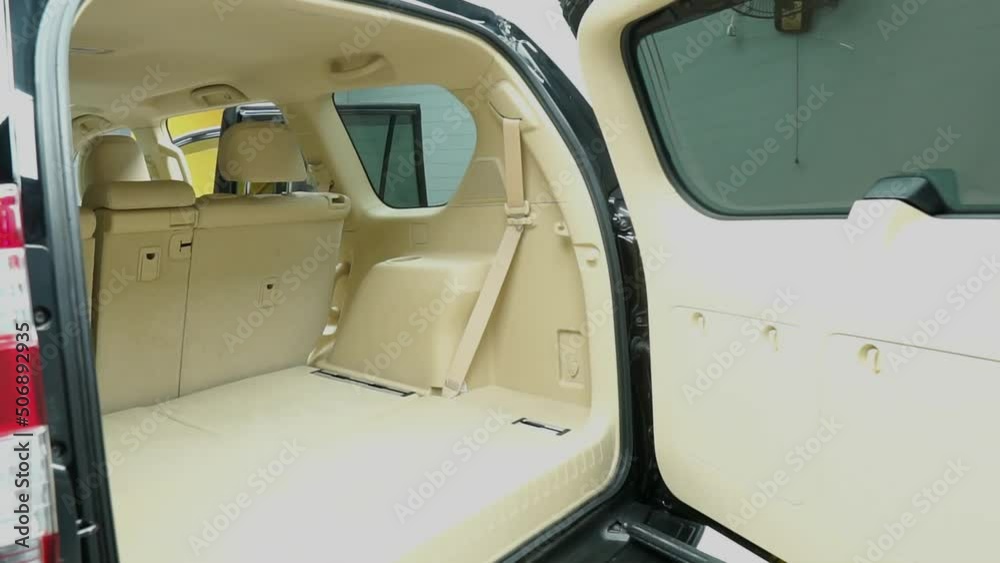 Close up shot of back view of car empty space in the backside of car. Demonstrating the automatic liftgate. New function of the car. Technology and transportation concepts Close up shot of back view of car empty space in the backside of car. Demonstrating the automatic liftgate. New function of the car. Technology and transportation concepts