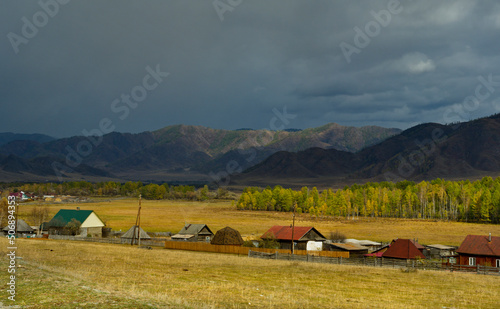 Russia. The South of Western Siberia, the Altai Mountains. Unpredictable weather over the village in the valley of the Karakol River.