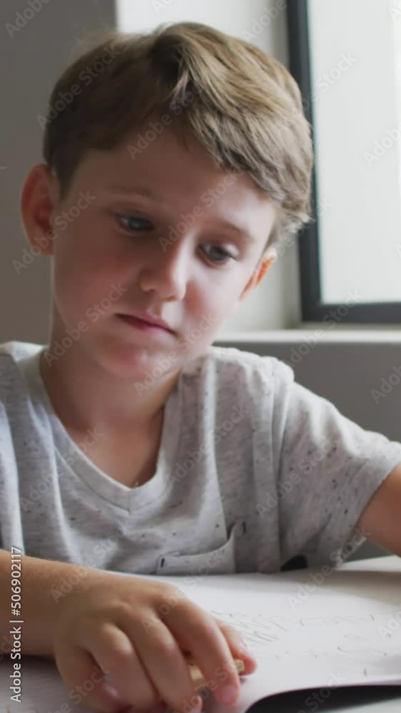 Video of focused caucasian boy doing lessons in classroom Video of focused caucasian boy doing lessons in classroom