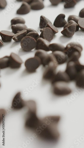 Video of close up of multiple chocolate chip over white background photo