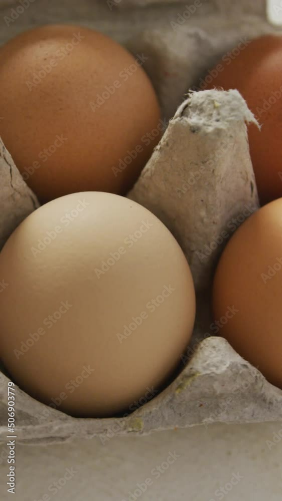 Video of overhead view of brown eggs in egg carton on rustic background Video of overhead view of brown eggs in egg carton on rustic background