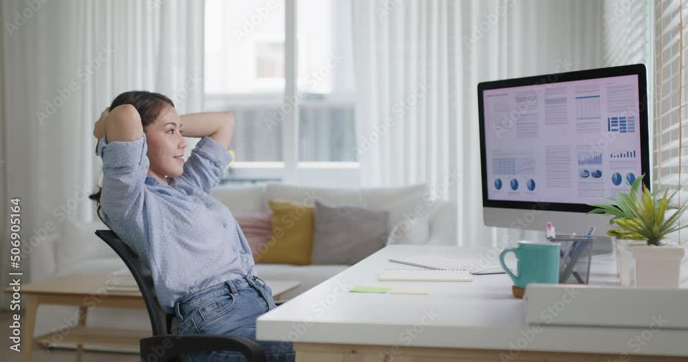 Asia people workforce young woman remote work at home office sit easy relax enjoy break time life balance put hands behind head and lean back on cozy desk. Teen girl stress relief look at desktop PC.