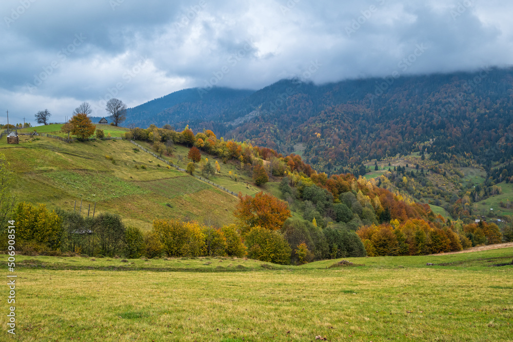 Cloudy and foggy day autumn mountains scene. Peaceful picturesque traveling, seasonal, nature and countryside beauty concept scene. Carpathian Mountains, Ukraine.