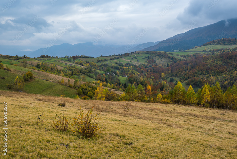 Cloudy and foggy day autumn mountains scene. Peaceful picturesque traveling, seasonal, nature and countryside beauty concept scene. Carpathian Mountains, Ukraine.