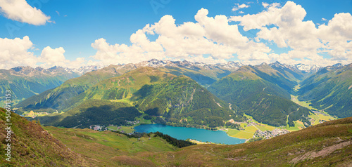 stunning lookout from Parsenn ridgeway to lake and tourist resort Davos, swiss alps. blue sky with clouds photo