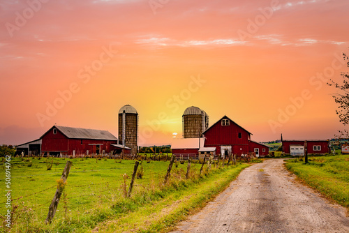 A farm with three red barns  in the finger Lakes Region of Upper New York photo