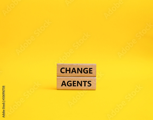 Change agents symbol. Concept word Change agents on wooden blocks. Beautiful yellow background. Business and Change agents concept. Copy space