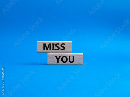 Miss you. Concept word Miss you on wooden cubes. Beautiful blue background. Business and Miss you concept. Copy space.