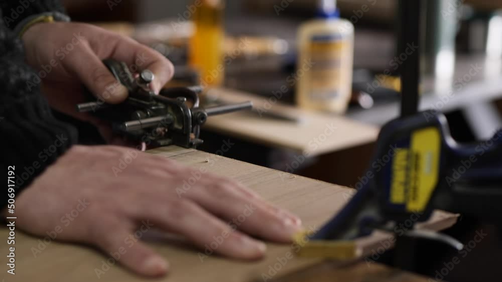 carpenter in the workshop makes furniture with a hand tool carpenter in the workshop makes furniture with a hand tool