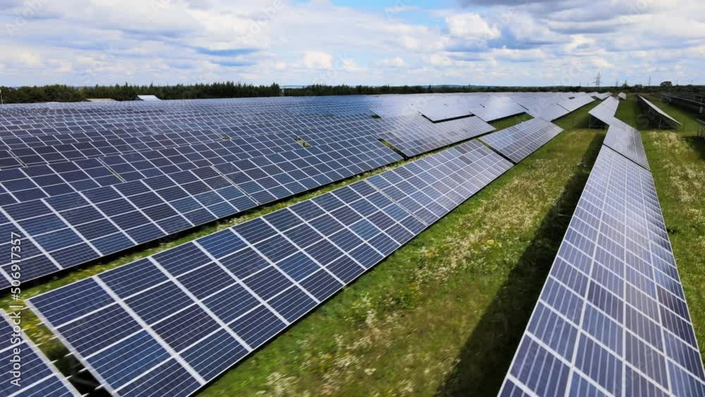 Aerial view of big sustainable electric power plant with many rows of solar photovoltaic panels for producing clean electrical energy. Renewable electricity with zero emission concept
