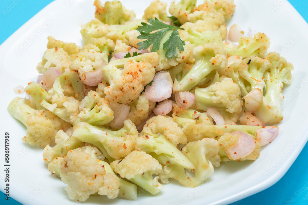 Healthy food cauliflower salad in plate dish on blue background. Healthy food cauliflower salad in plate dish on blue background.