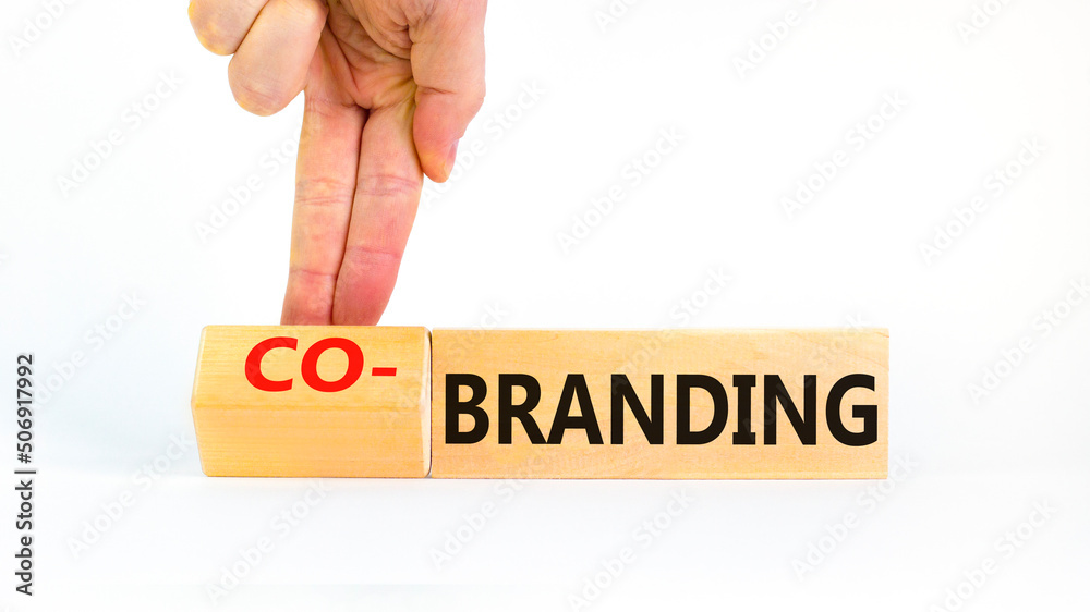 Branding or cobranding symbol. Businessman turns wooden cubes and