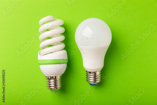 Electric light bulbs. the concept of energy efficiency. LED lamp vs incandescent lamp. Composition on a green background. Use an economical and environmentally friendly light bulb concept.