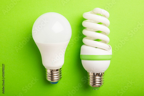 Electric light bulbs. the concept of energy efficiency. LED lamp vs incandescent lamp. Composition on a green background. Use an economical and environmentally friendly light bulb concept.