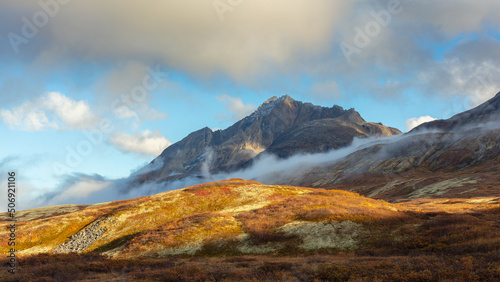 Mountain landscape in autumn colors with mist and low clouds, Kluane National Park, Canada