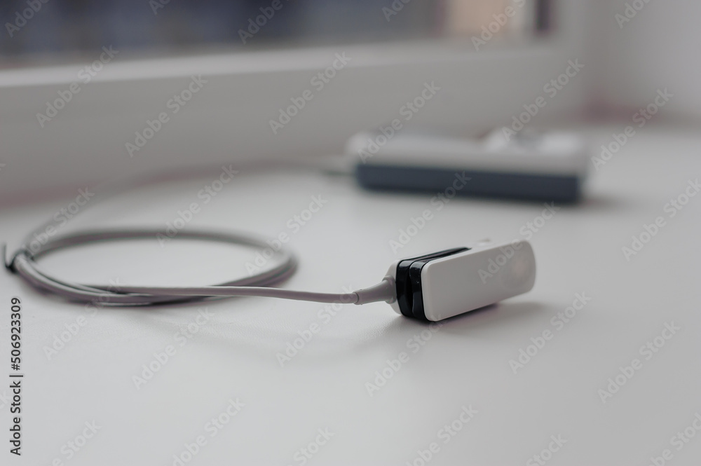 Pulse oximeter on a white background. Medical control and diagnostic device for measuring the saturation of capillary blood with oxygen Pulse oximeter on a white background. Medical control and diagnostic device for measuring the saturation of capillary blood with oxygen