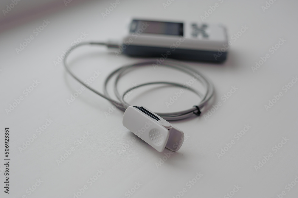Pulse oximeter on a white background. Medical control and diagnostic device for measuring the saturation of capillary blood with oxygen Pulse oximeter on a white background. Medical control and diagnostic device for measuring the saturation of capillary blood with oxygen