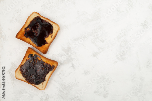Hot toast for breakfast. Roasted Aussie savory toasts with vegemite. Vegemite is a very popular yeast based spread in Australia photo