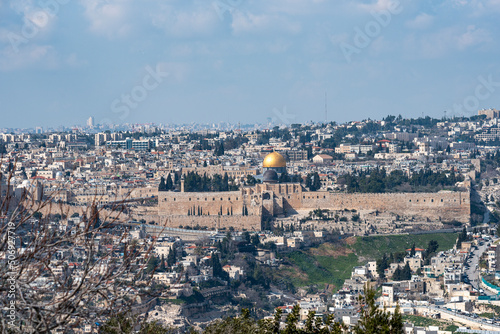 Jerusalem old city, holy mountain. Jerusalem of Gold under cloudy sky - old town view from Mount of Olives