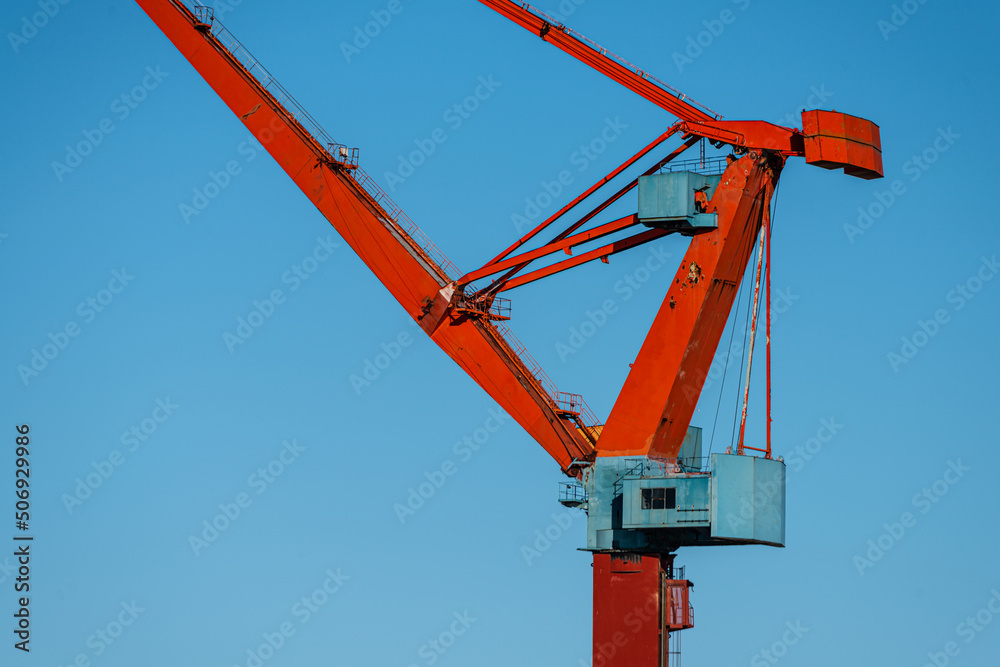 Arm and steering house of an old red yard crane. Arm and steering house of an old red yard crane.