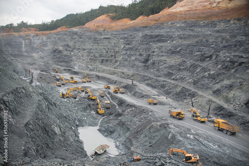 A large quarry dump truck in a coal mine. Loading coal into body work truck. Mining equipment for the transportation of minerals.