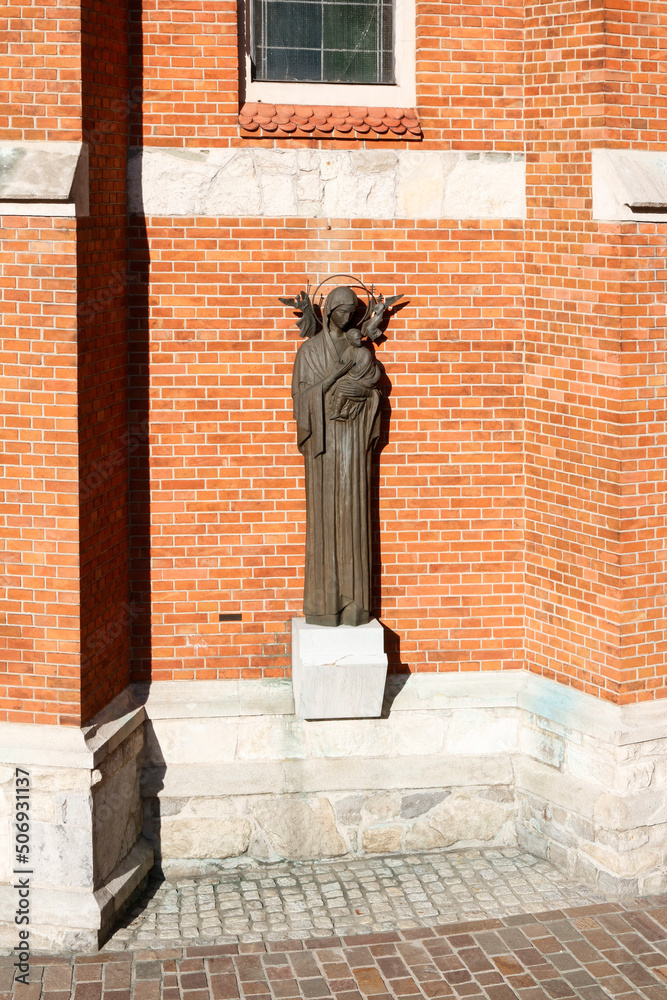 Naklejka premium KRAKOW, POLAND - MAY 10, 2022: A statue by St. Joseph Church a historic Roman Catholic church in Podgorze district of Krakow, Poland.