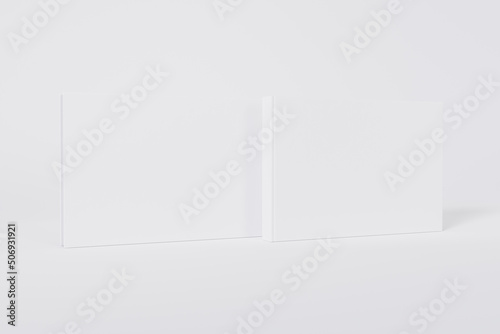 Mockup of a rectangular book with a blank glossy white cover on white background. Front and back cover visible. Isolated with clipping path.	