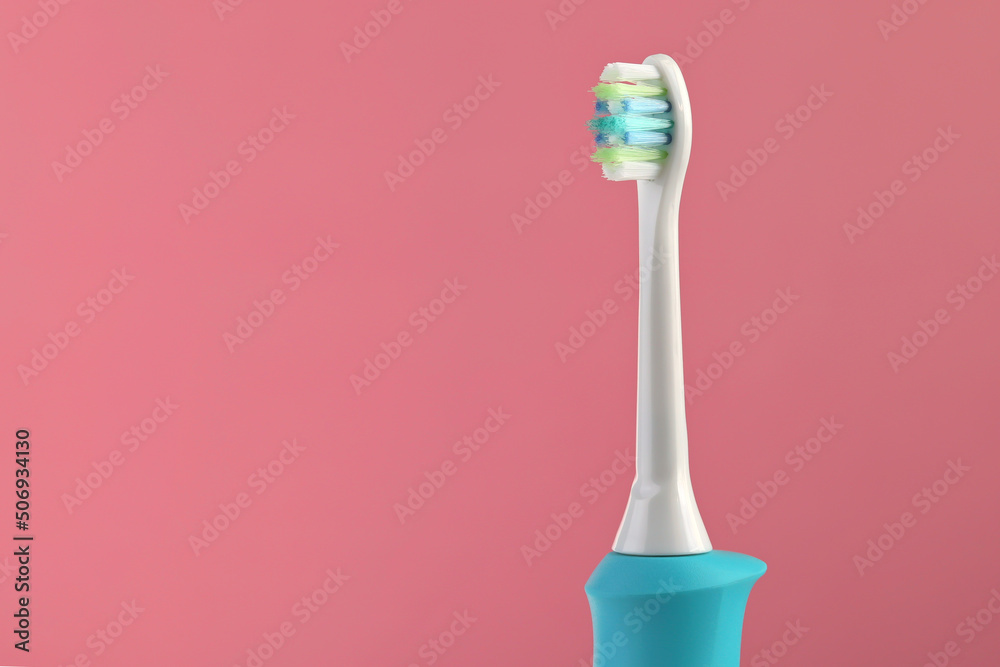 dental sonic electric brush, hygiene concept. Pink background, space for text - obrazy, fototapety, plakaty 
