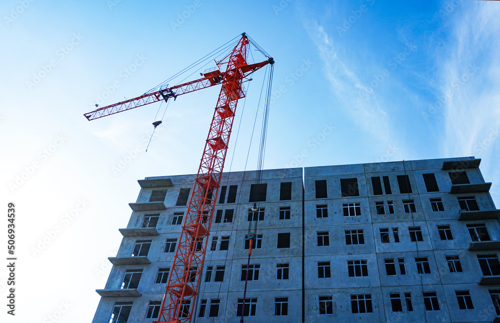 Fototapeta premium A crane that builds multi-story homes