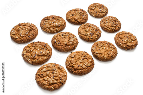 Oatmeal cookies lie in rows on a white background
