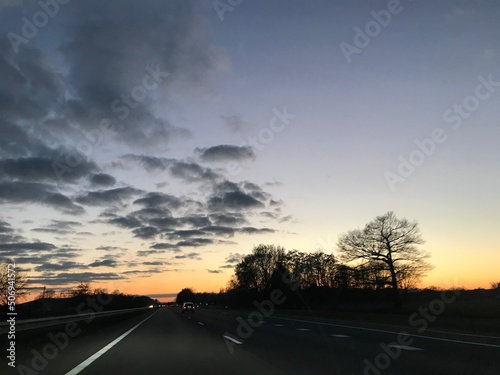 driving on the highway at sunset © CookiemanProductions