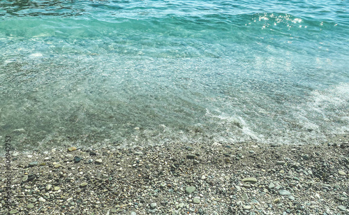 stones on the beach. pebble beach, seaside vacation, travel to a hot and warm country. texture with stones. next to the beach water, sea wave © Aliaksandra