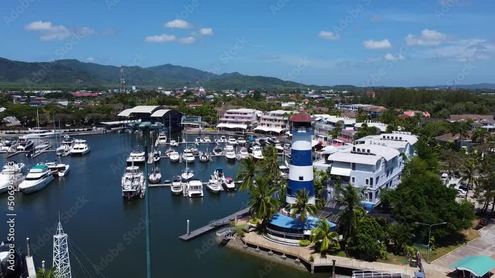 Lighthouse at the entrance to the yacht marina, aerial view of the marina and yacht parking Lighthouse at the entrance to the yacht marina, aerial view of the marina and yacht parking
