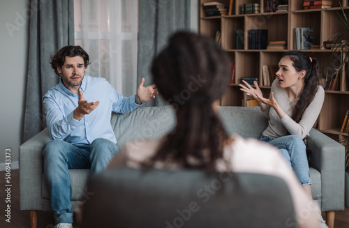 Young african american lady psychologist consults unhappy emotional european couple, husband and wife quarrel